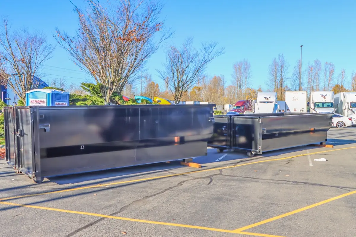 Professional dumpster rental service with roll-off container on residential driveway in Starke